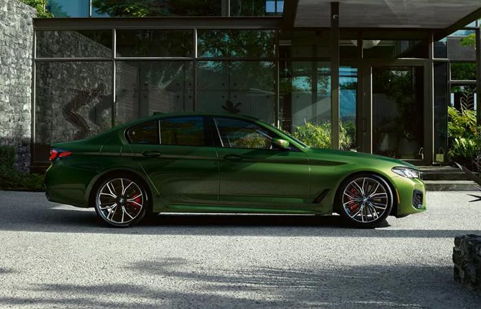 Side profile view of a green 2021 BMW 5 Series