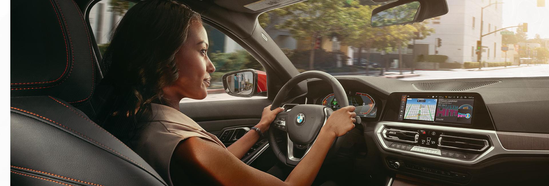 A lady driving the 2021 BMW 3 Series in Miami, Fl