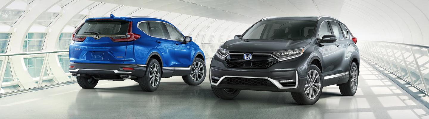 A Blue and a gray 2021 Honda CR-V parked next to each other.