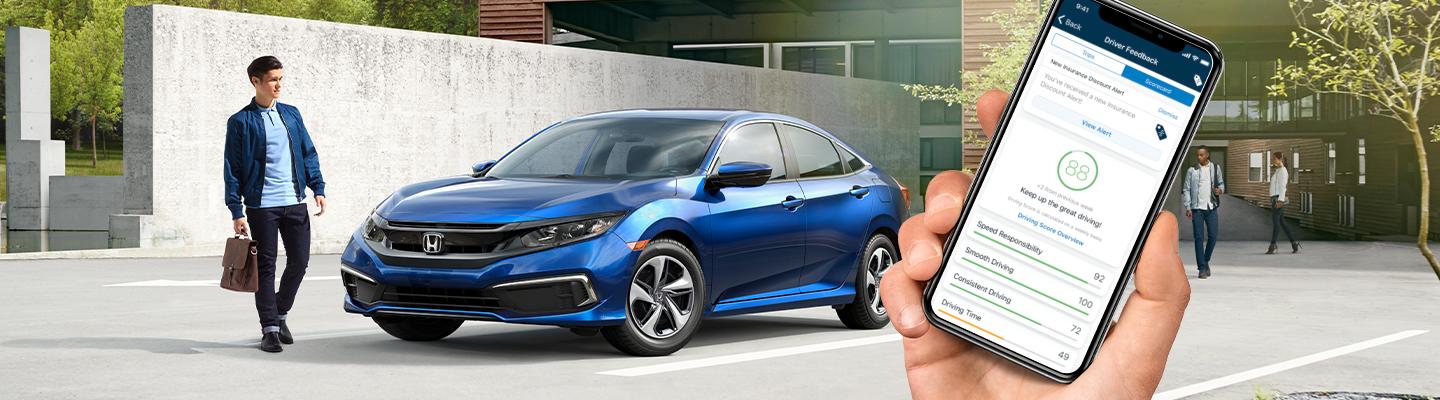 Honda driver walking next to a new Honda from South Motors Honda using the Hondalink app.