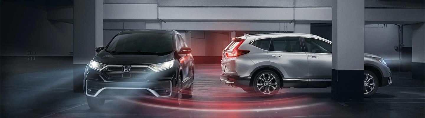 Two Honda CR-V's using technology to keep safe at a parking garage