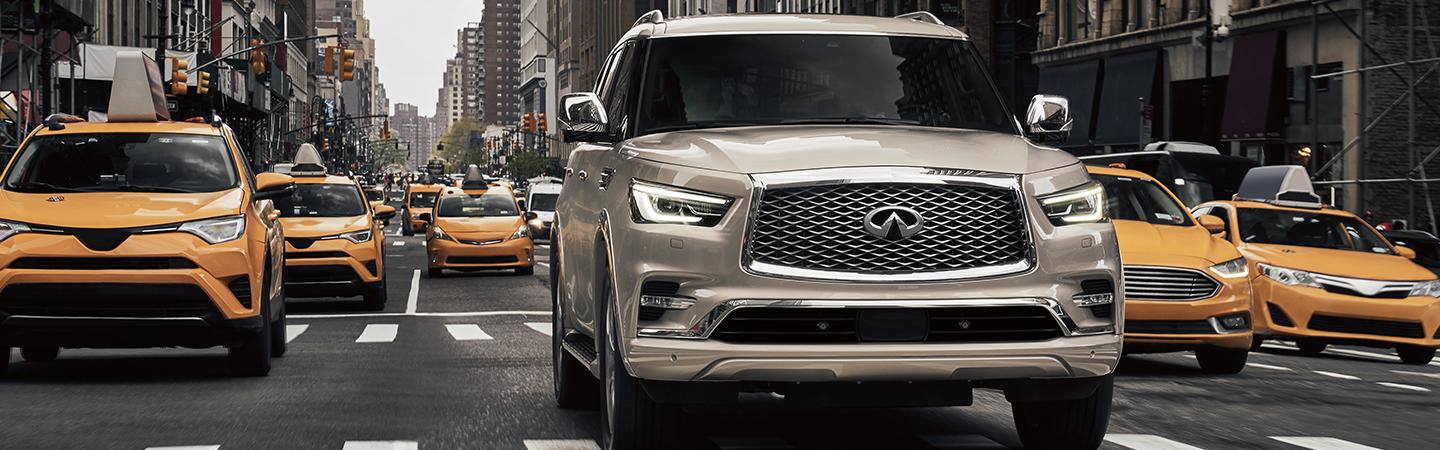 Front view of a white 2021 QX80 in traffic