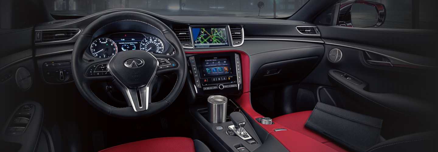 The steering wheel, infotainment system, and dash in the INFINITI QX55.