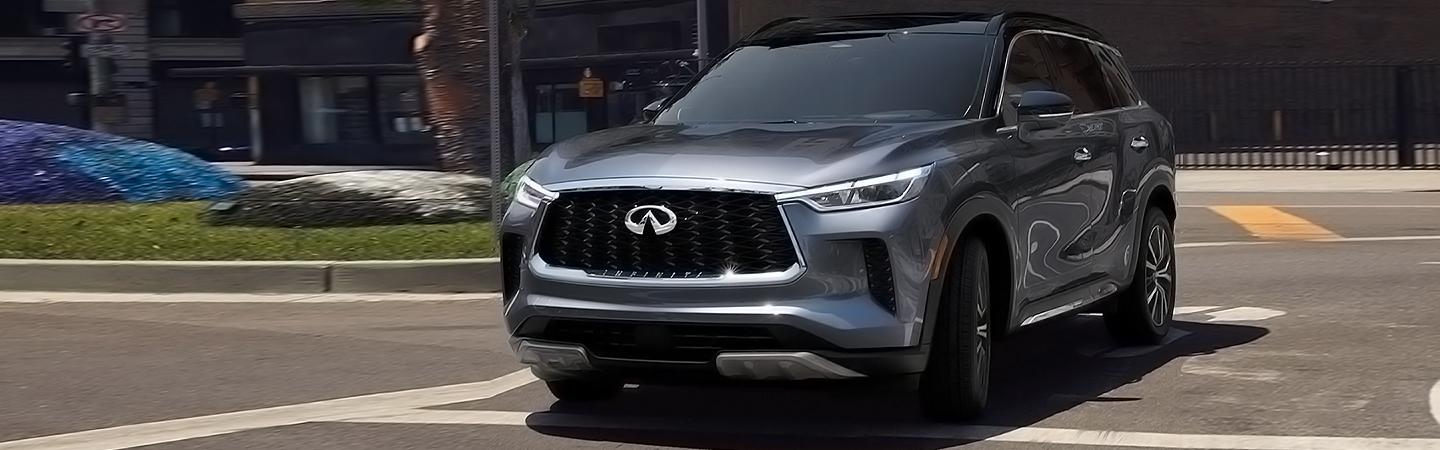 Front view of the 2023 INFINITI QX60 driving in the city