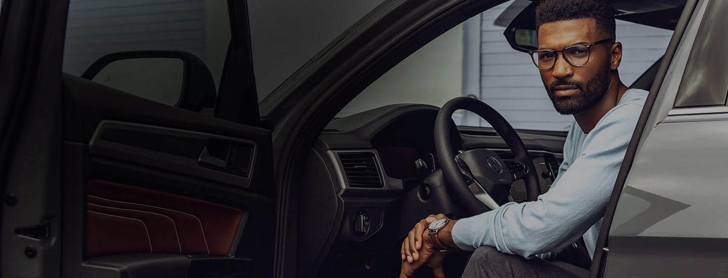 guy siting in a volkswagen car