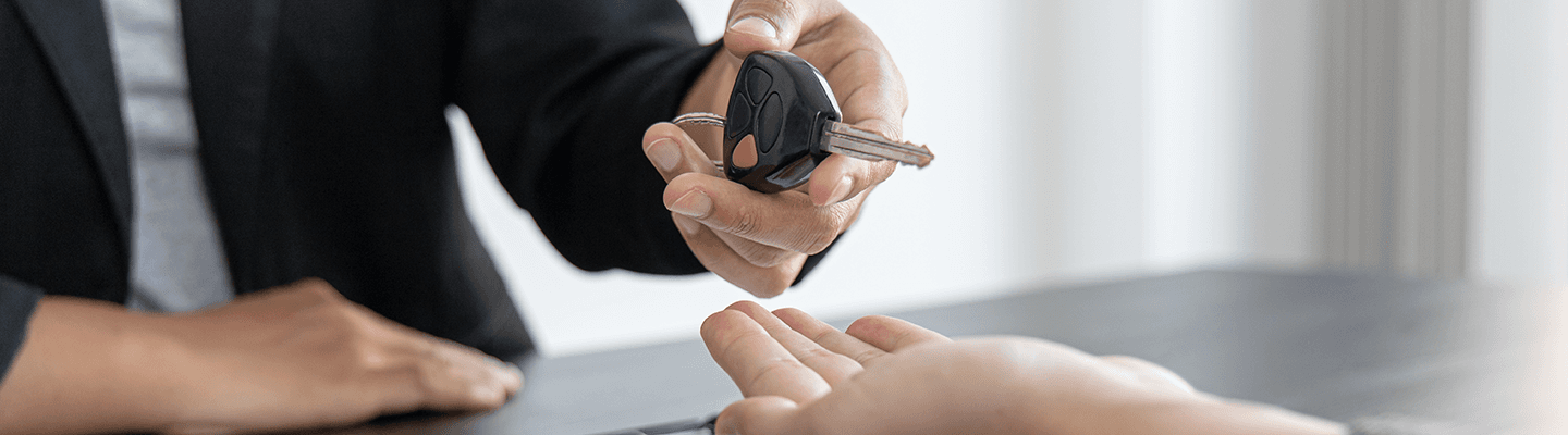 A Volkswagen team professional handing over keys to a new VW Customer.