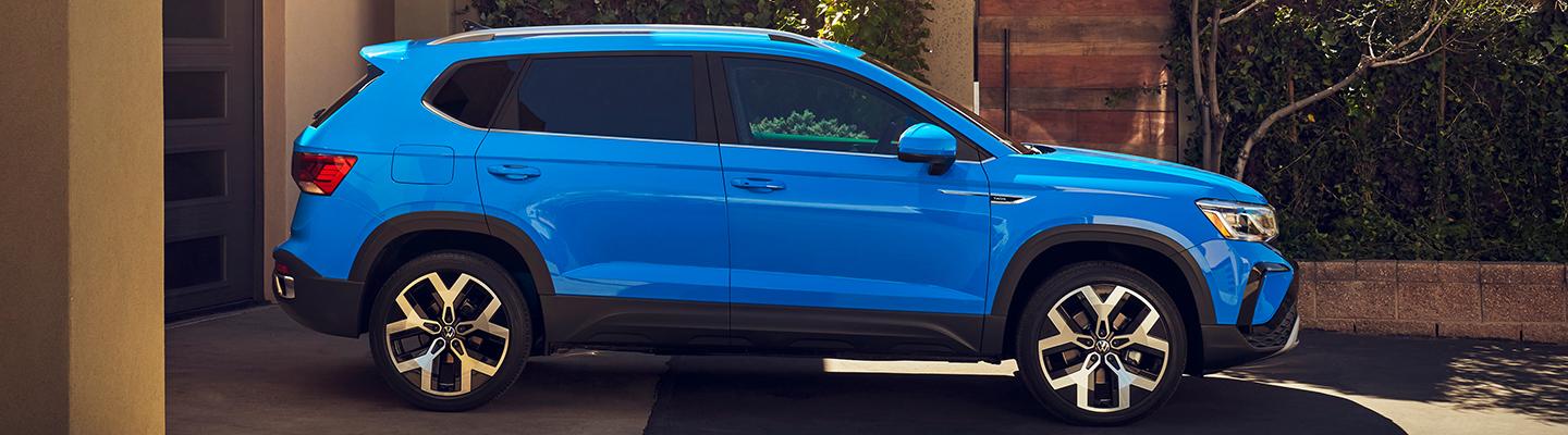 Side profile view of a blue 2021 VW Taos