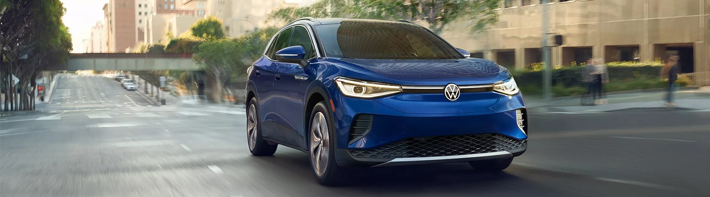 The metallic blue electric Volkswagen in motion